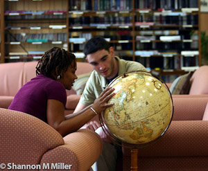 Students Looking At Globe